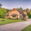 A beautiful home with a driveway and trees.